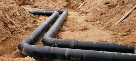 Underground pipes installed in a trench, showcasing industrial plumbing work relevant to Clearwater Plumbing and Civil's services in Sydney and surrounding areas.